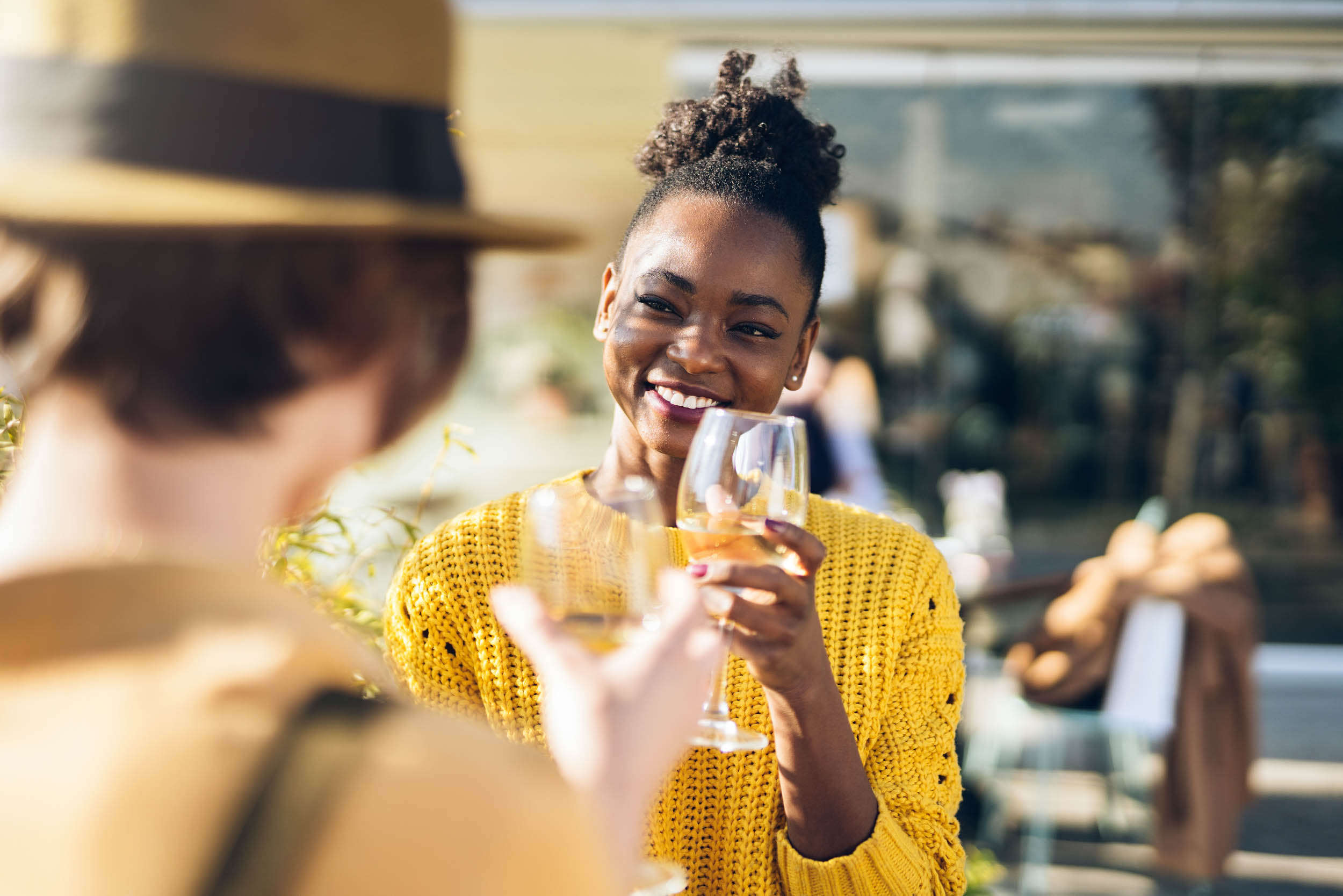 Two friends smiling in a restaurant near Wellory Living - Luxury apartments for rent in Huntsville, AL
